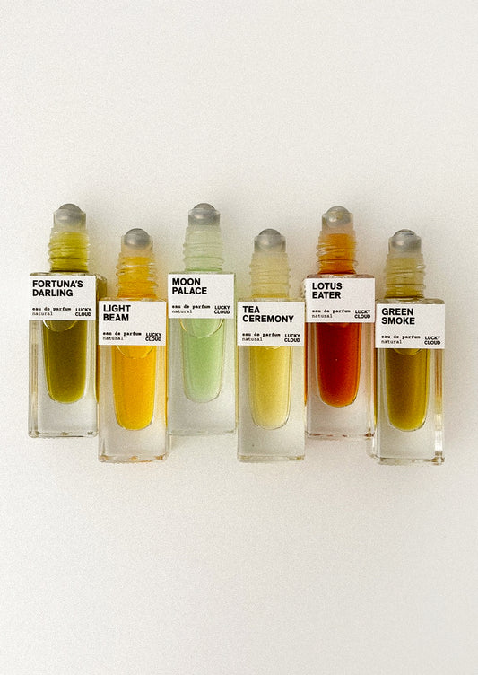Set of small perfume bottles with labels on a white background