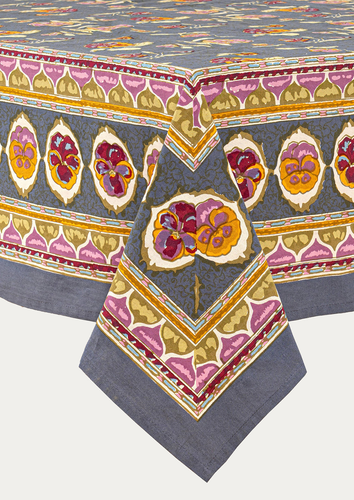 Decorative tablecloth with floral and geometric patterns on a white background