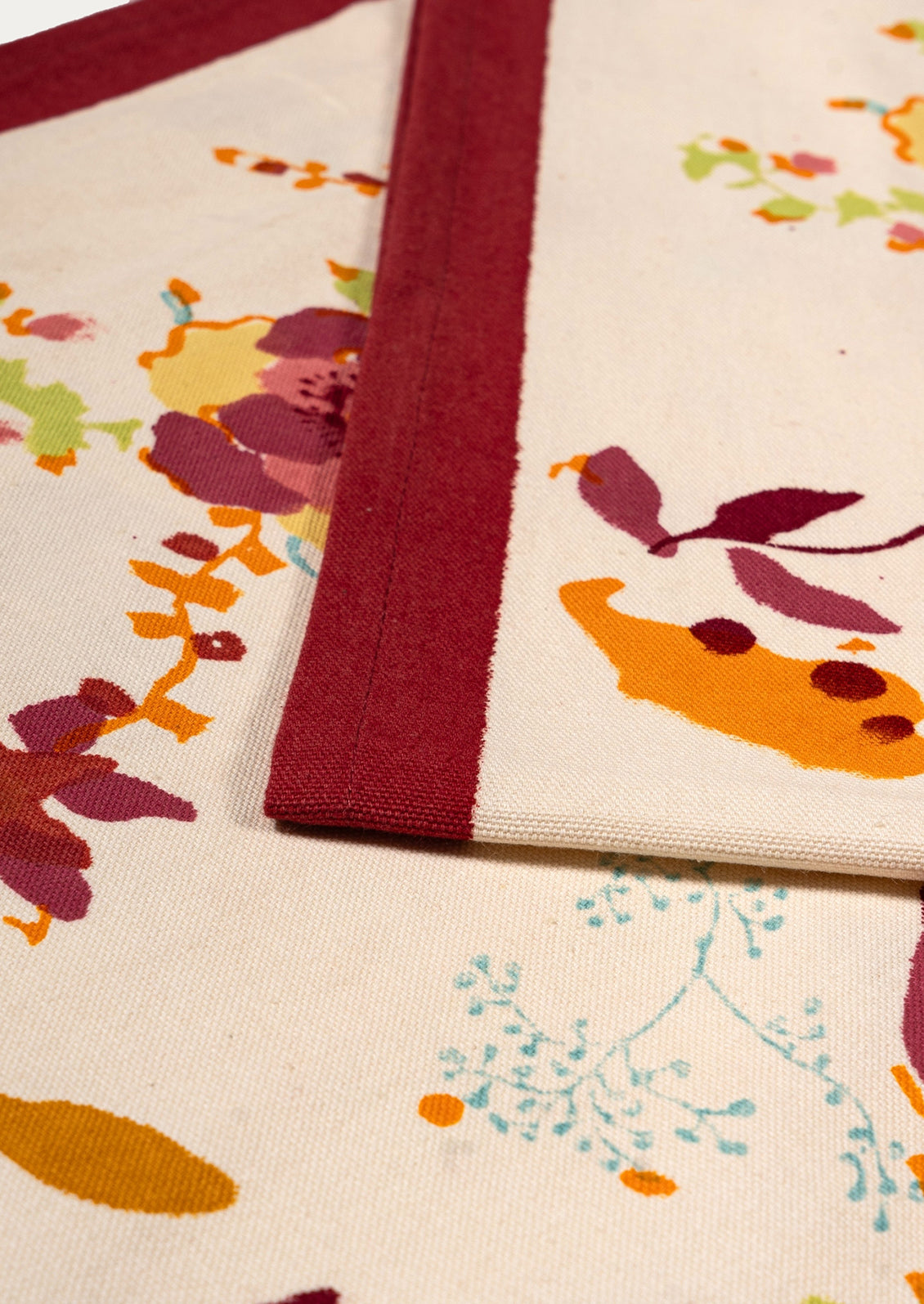 Floral patterned fabric with a red border on a white background