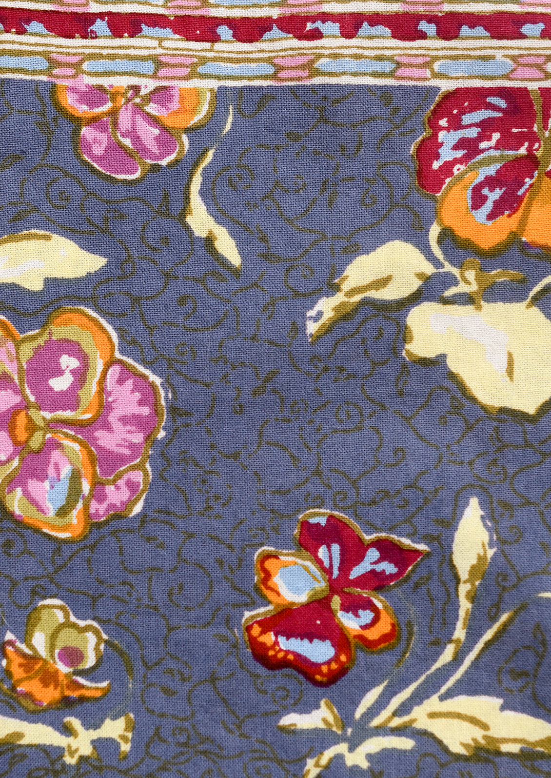 Floral patterned fabric with colorful flowers on a blue background