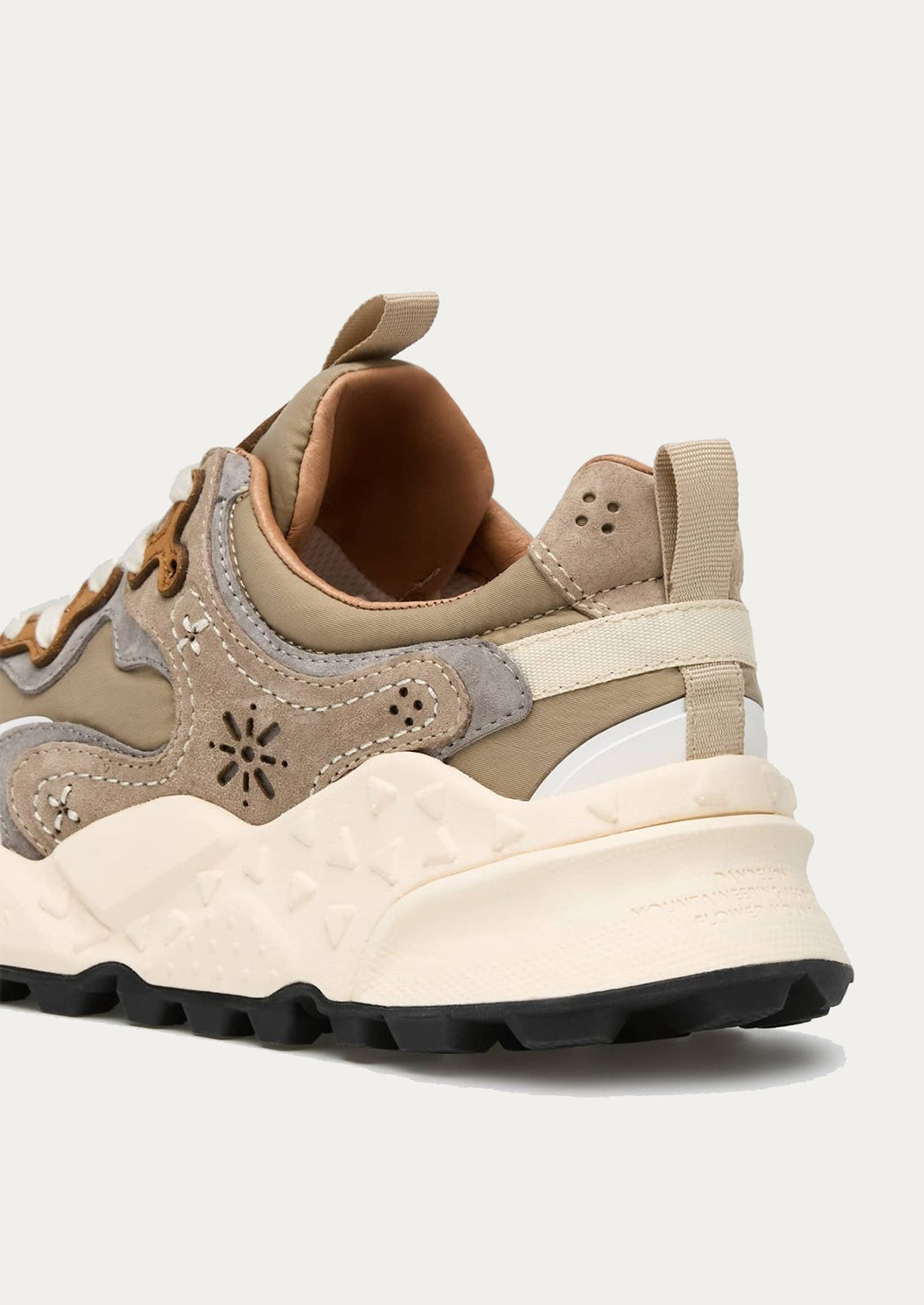 A sporty unisex sneaker in taupe, grey and brown.