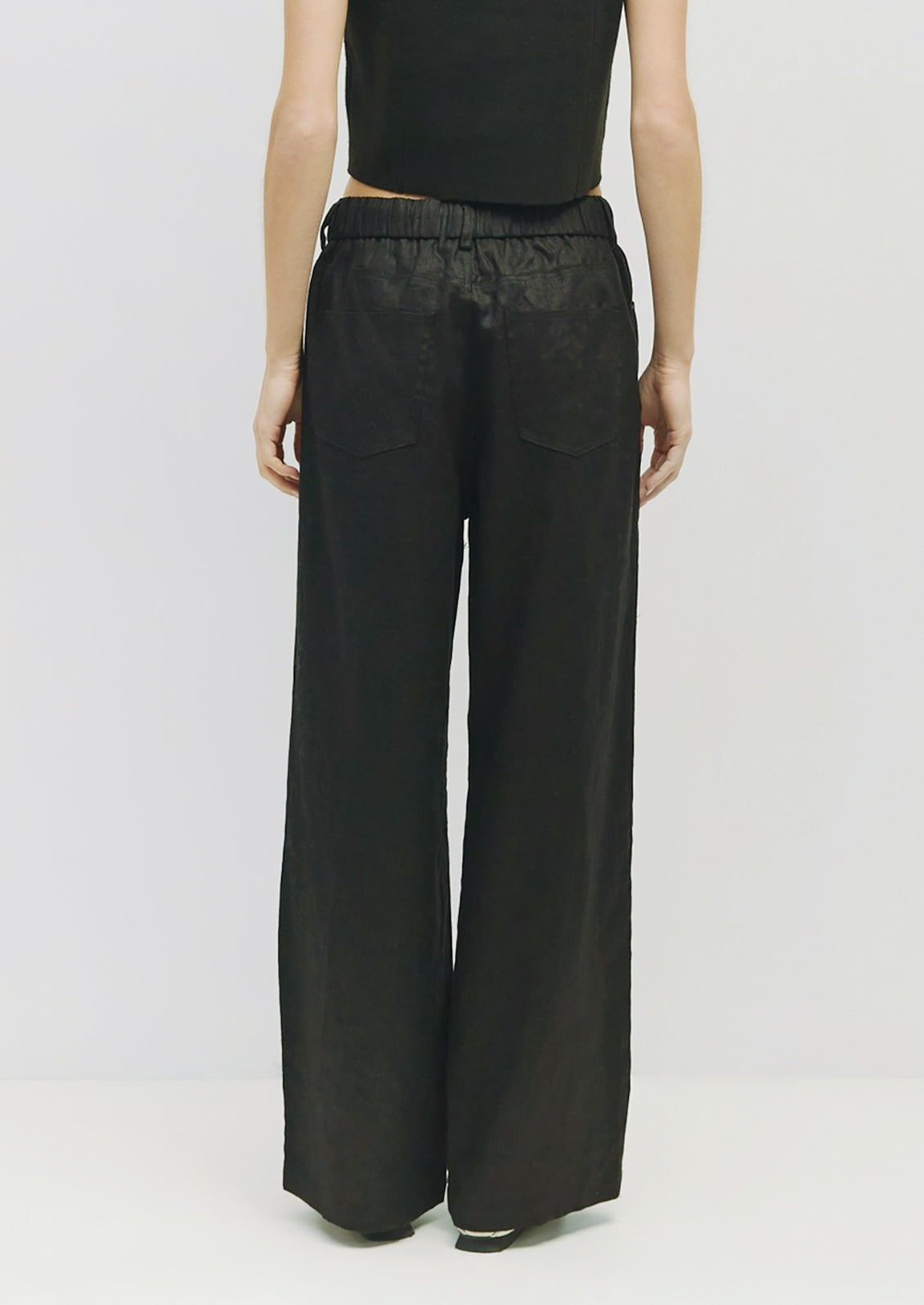 A pair of black linen pants with utility look.