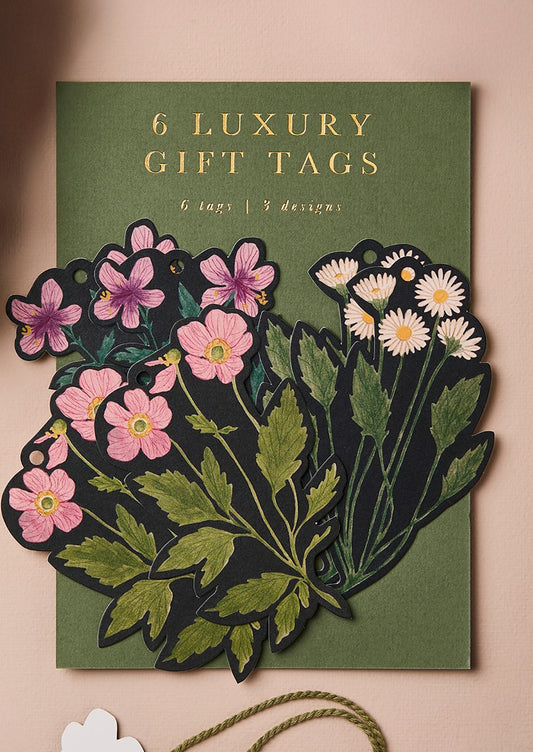 Packaging of 6 luxury gift tags with floral designs on a green background