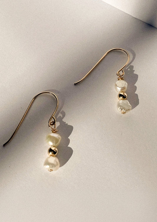 Pair of gold earrings with pearl beads.