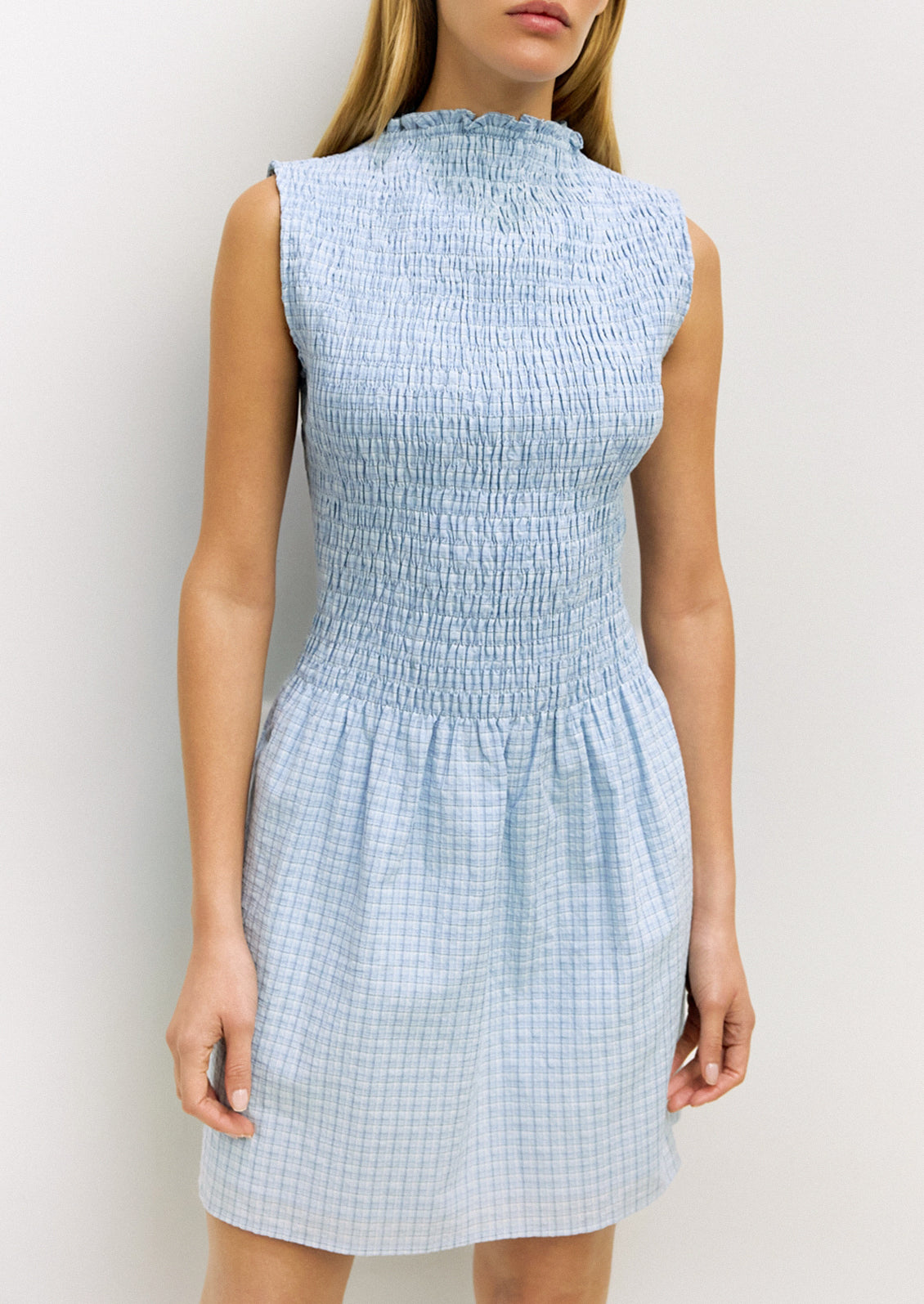 Light blue checkered dress worn by a model against a white background