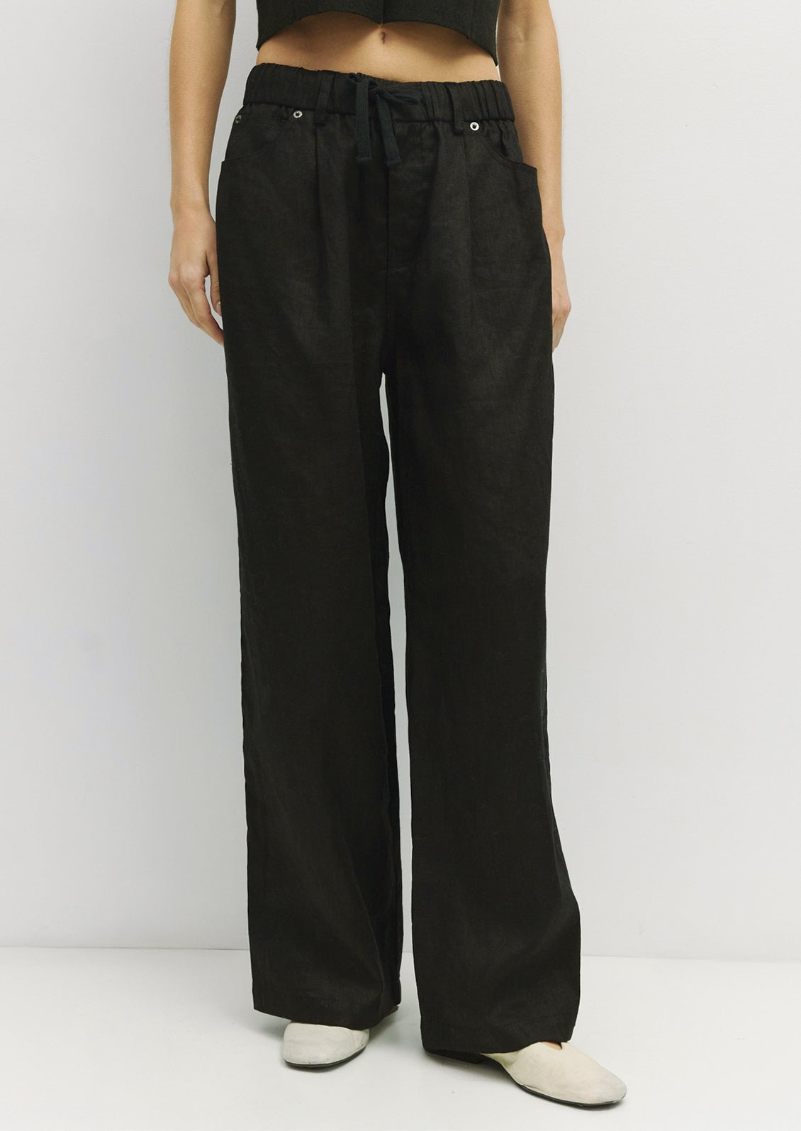 A pair of black linen pants with utility look.