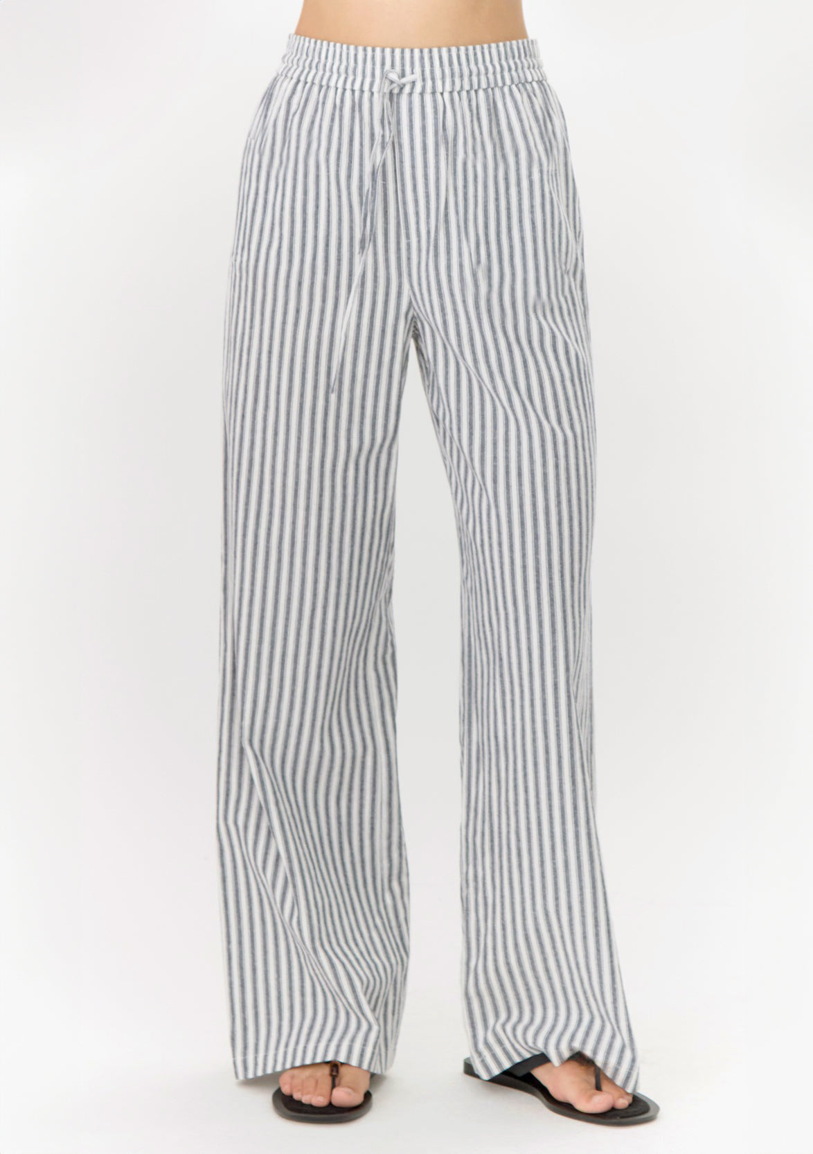Striped pants worn by a person on a white background