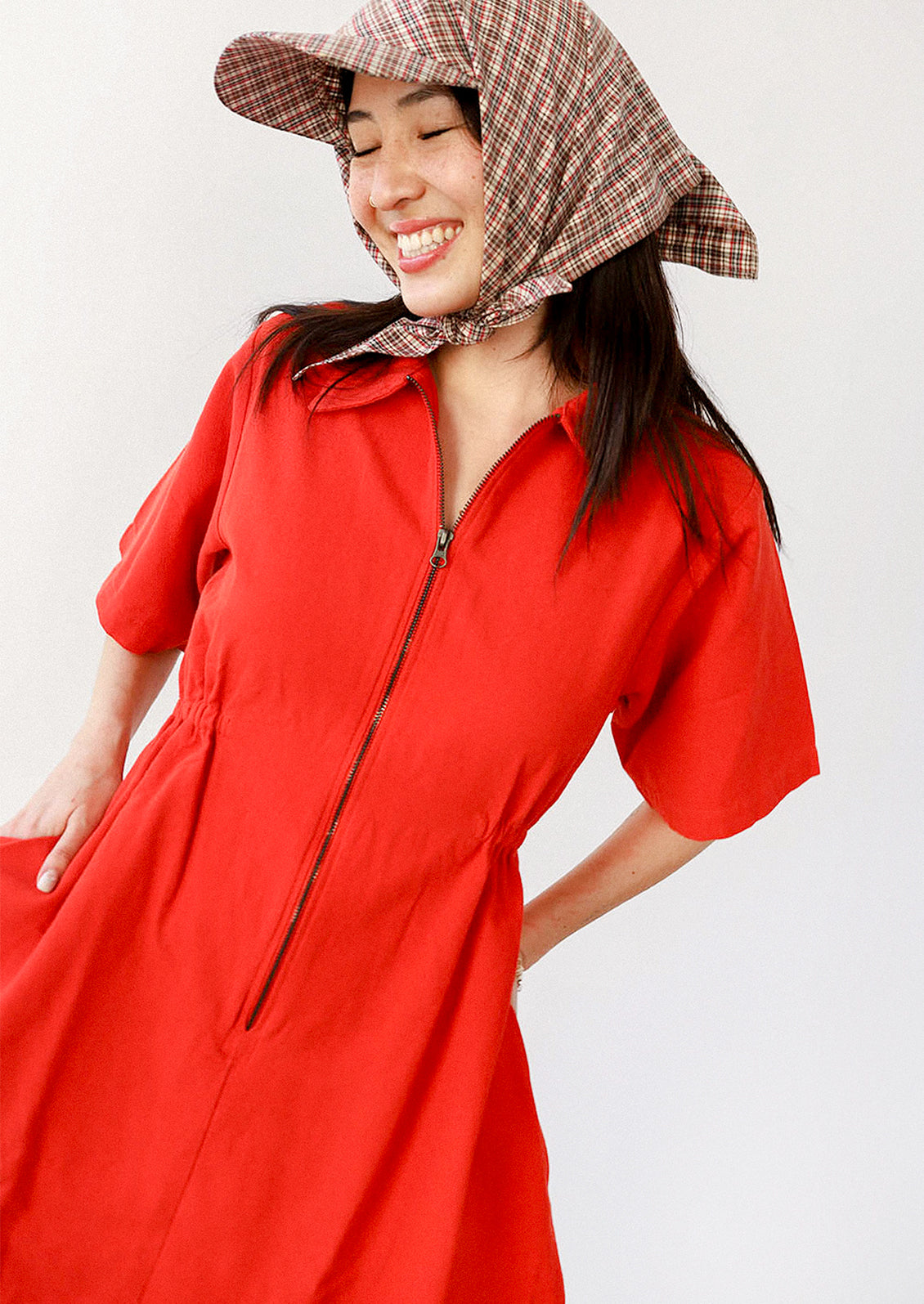 Red dress with a zipper on a white background