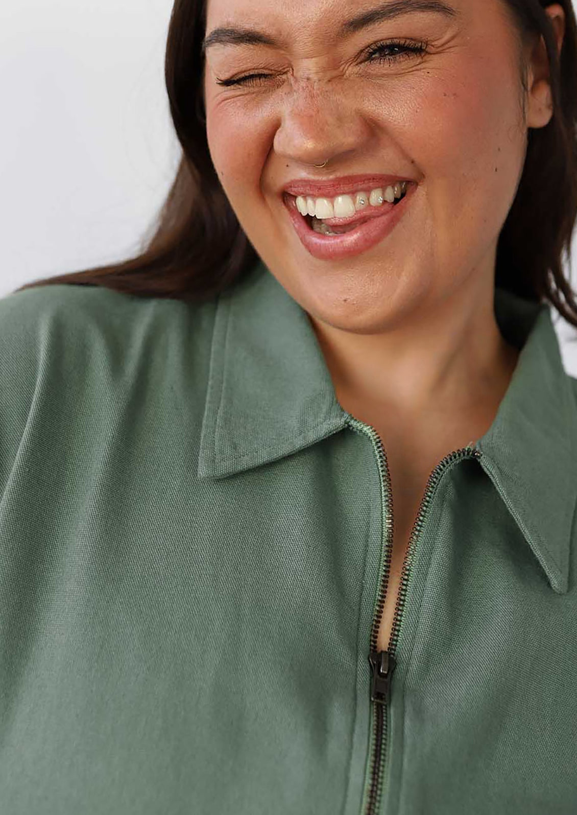 Woman wearing a green dress with a close-up of her face.