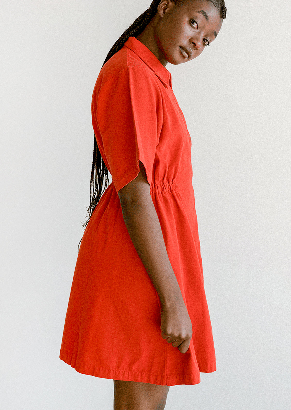 Woman wearing a red dress against a white background