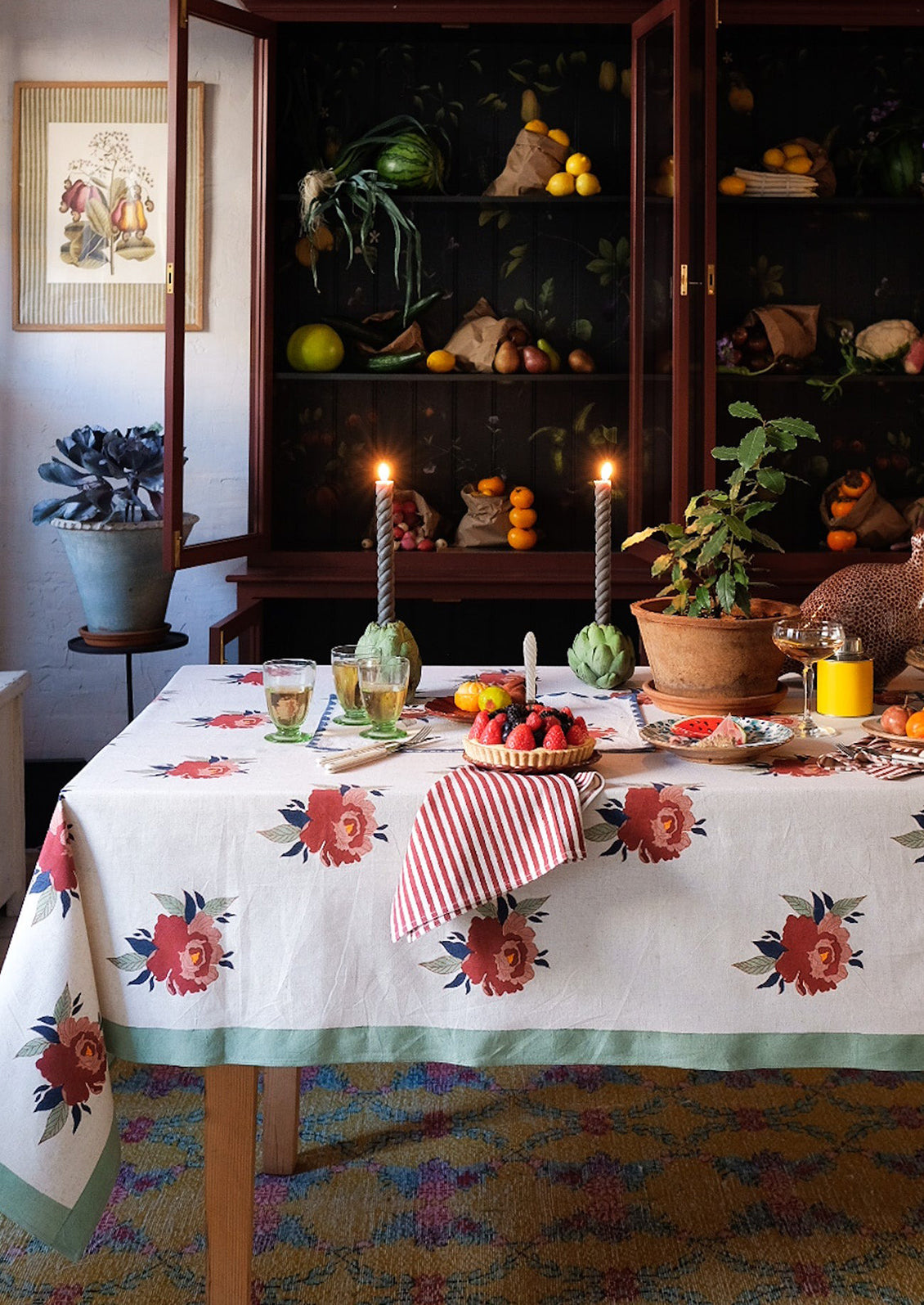 A floral print tablecloth with mint green border.