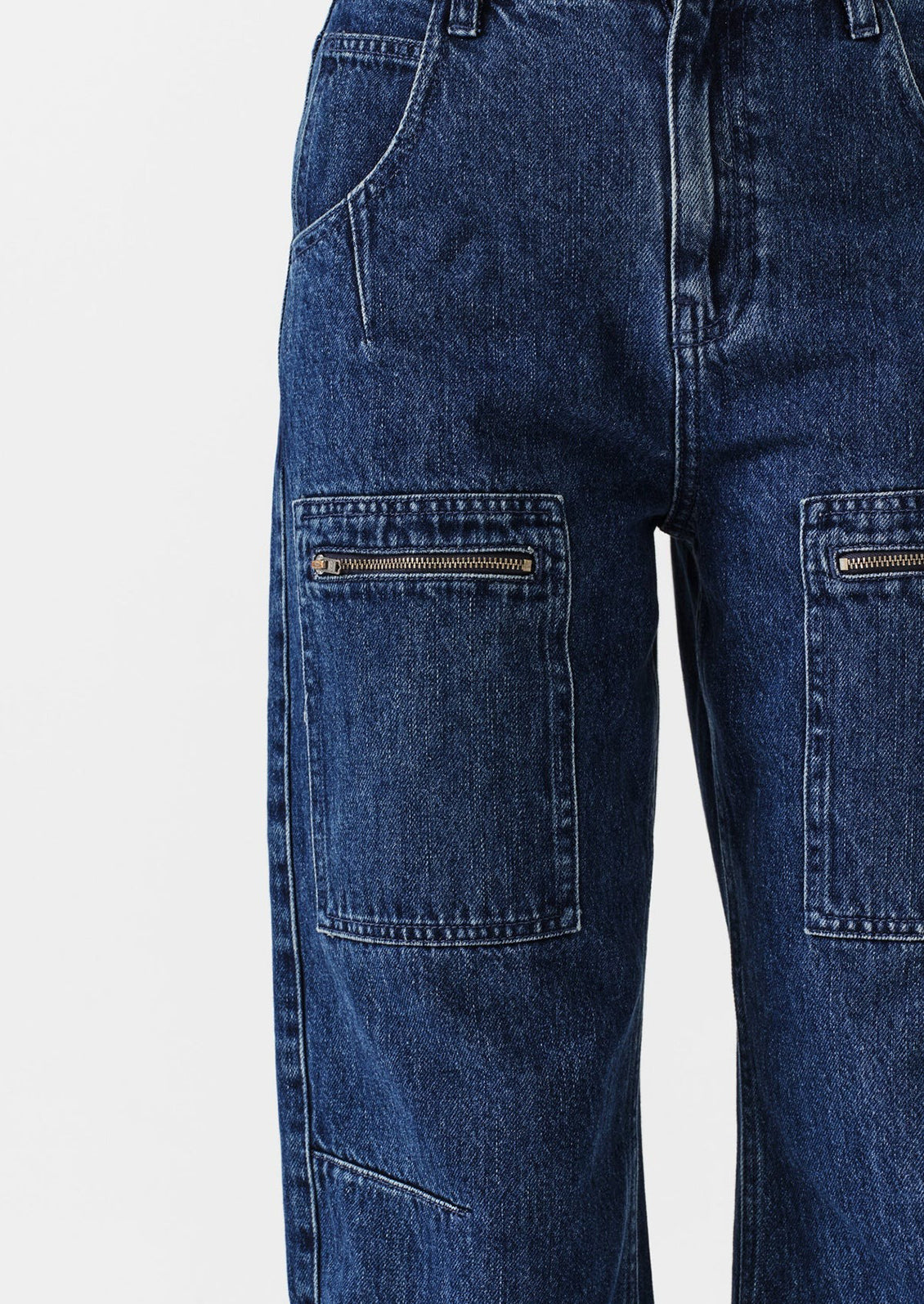 Close-up of blue jeans with zippers on a white background