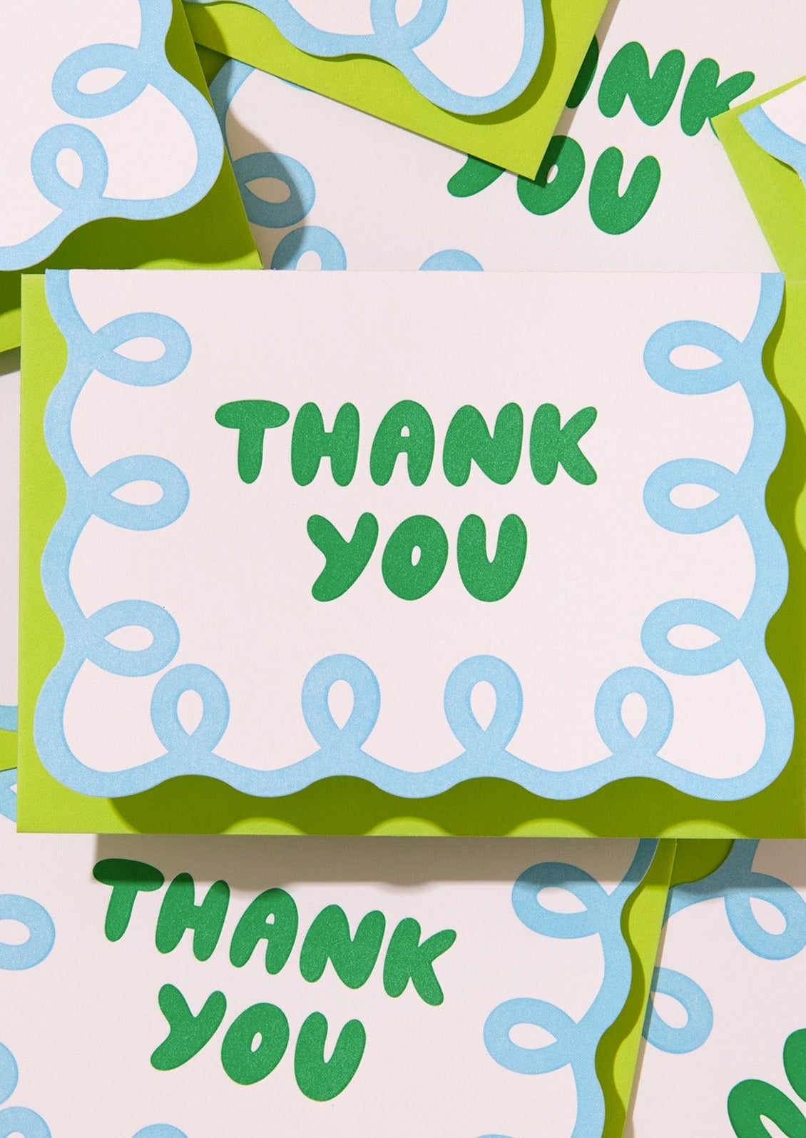 Card with 'Thank You' text in green on a white background with blue and green decorative elements.
