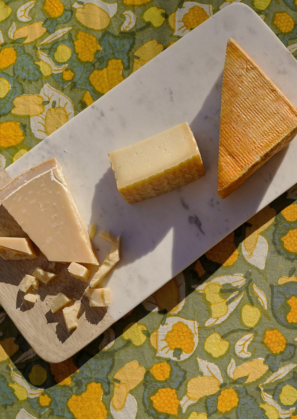 A table setting with green and yellow tablecloth.