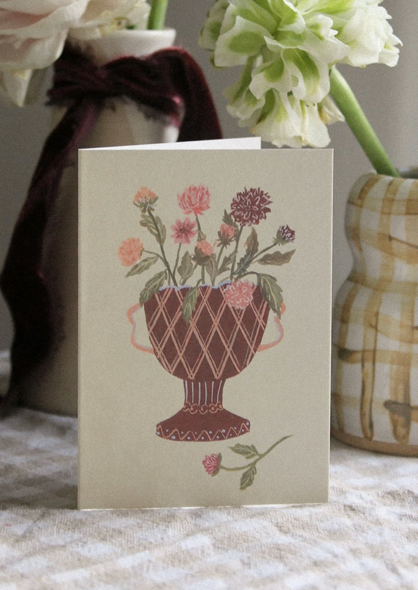 A mini greeting card in sage green with illustration of pink dahlia flowers in vase.