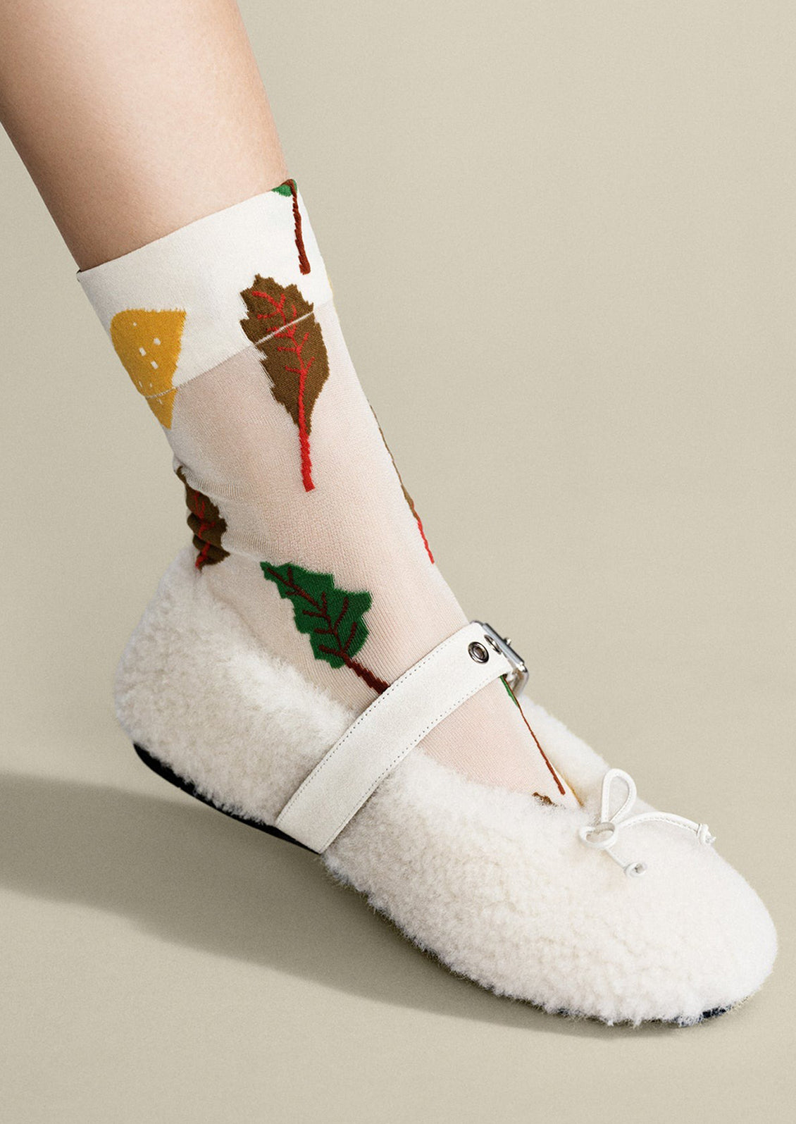 A pair of sheer white nylon socks with swiss chard pattern.
