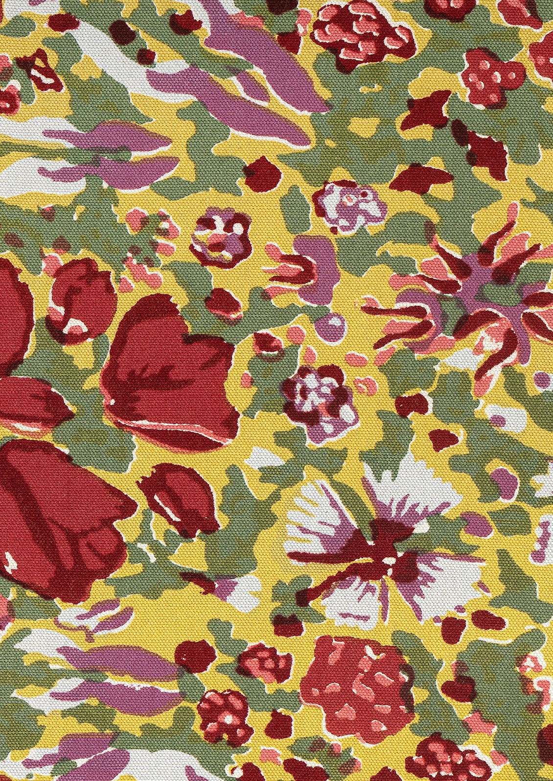 A floral patterned table runner in green with red, yellow, white and purple pattern.