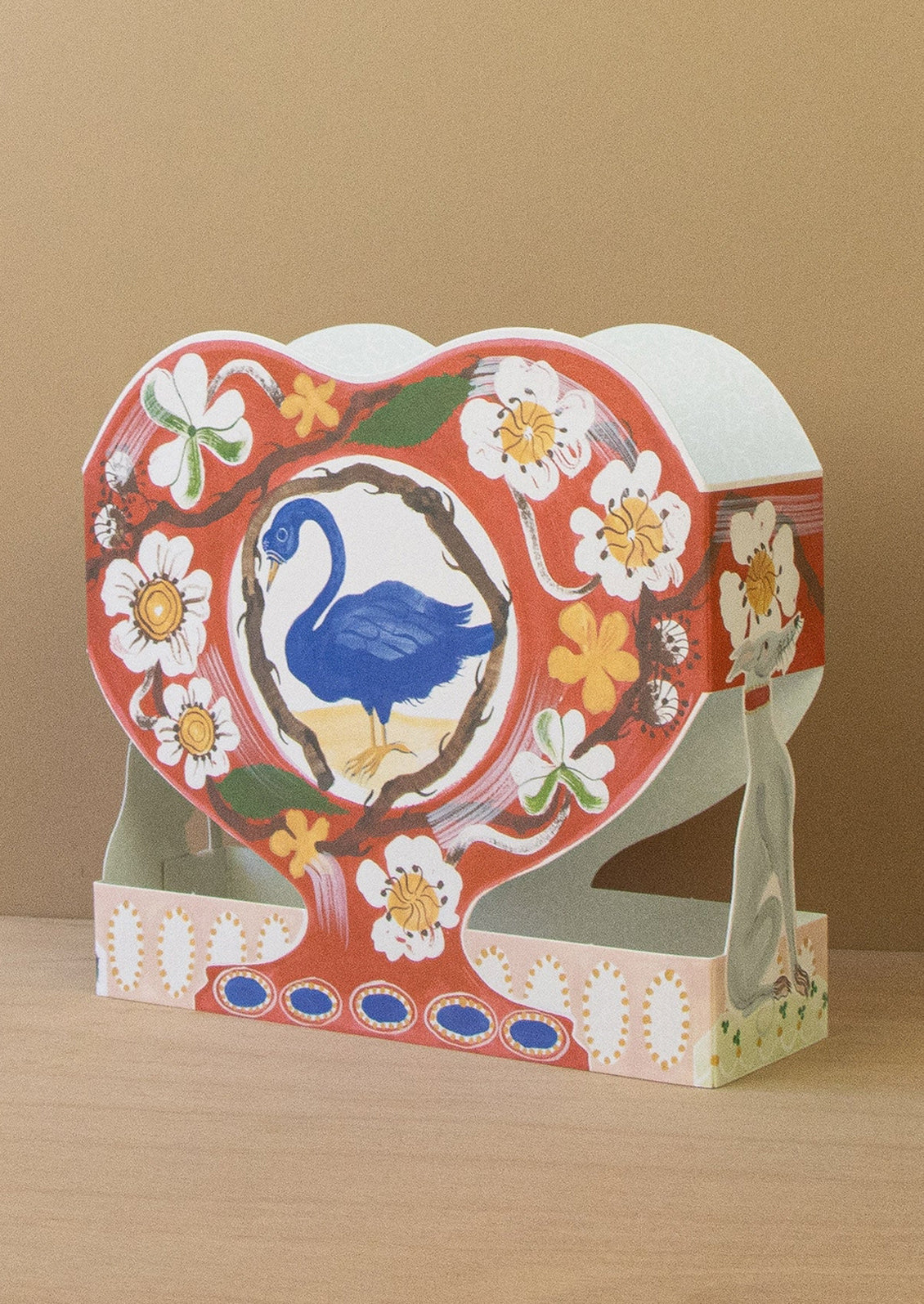 Decorative stand with a swan design on a beige background
