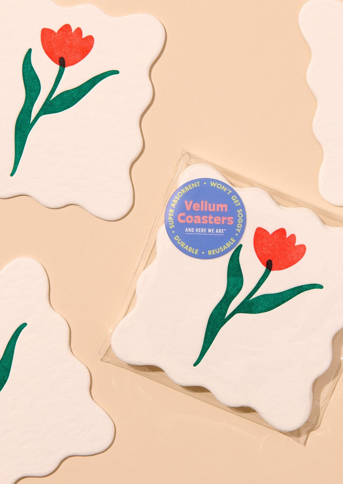Coasters with tulip design and 'Vellum Coasters' branding on a beige background