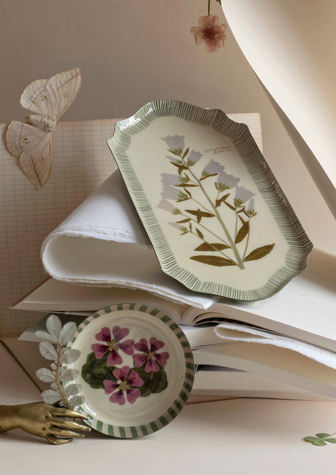 Decorative plates with floral designs on top of an open book
