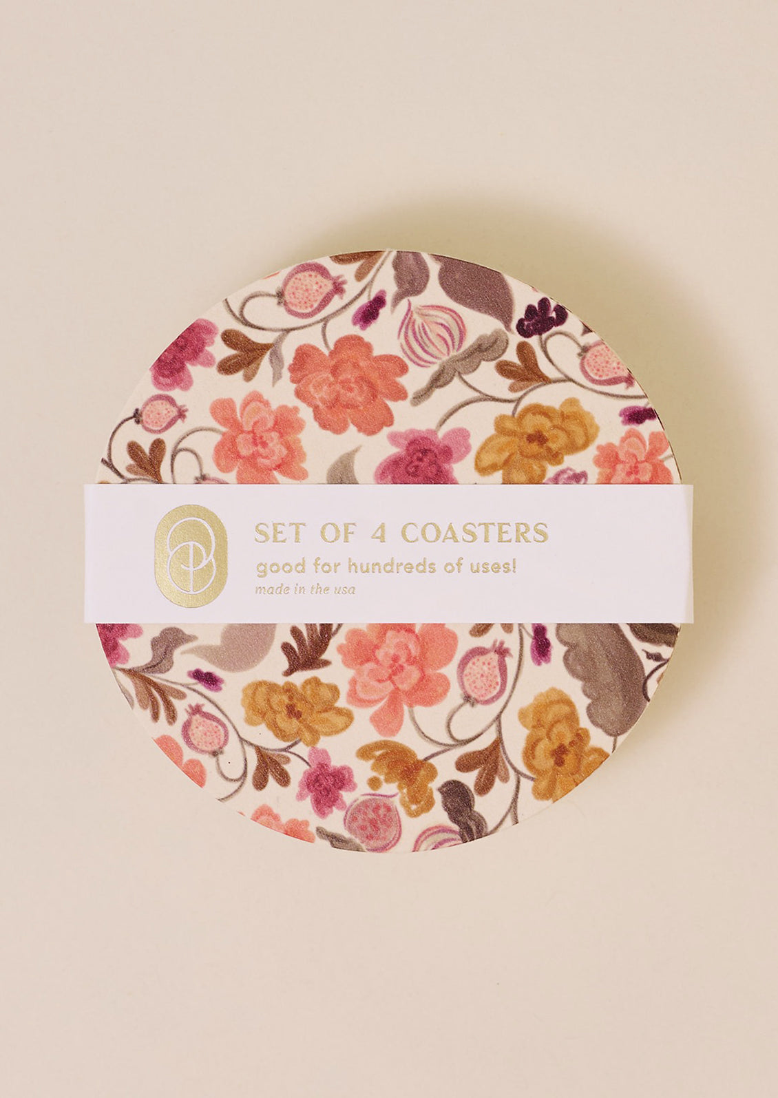 A set of paper coasters in pink and yellow floral pattern.