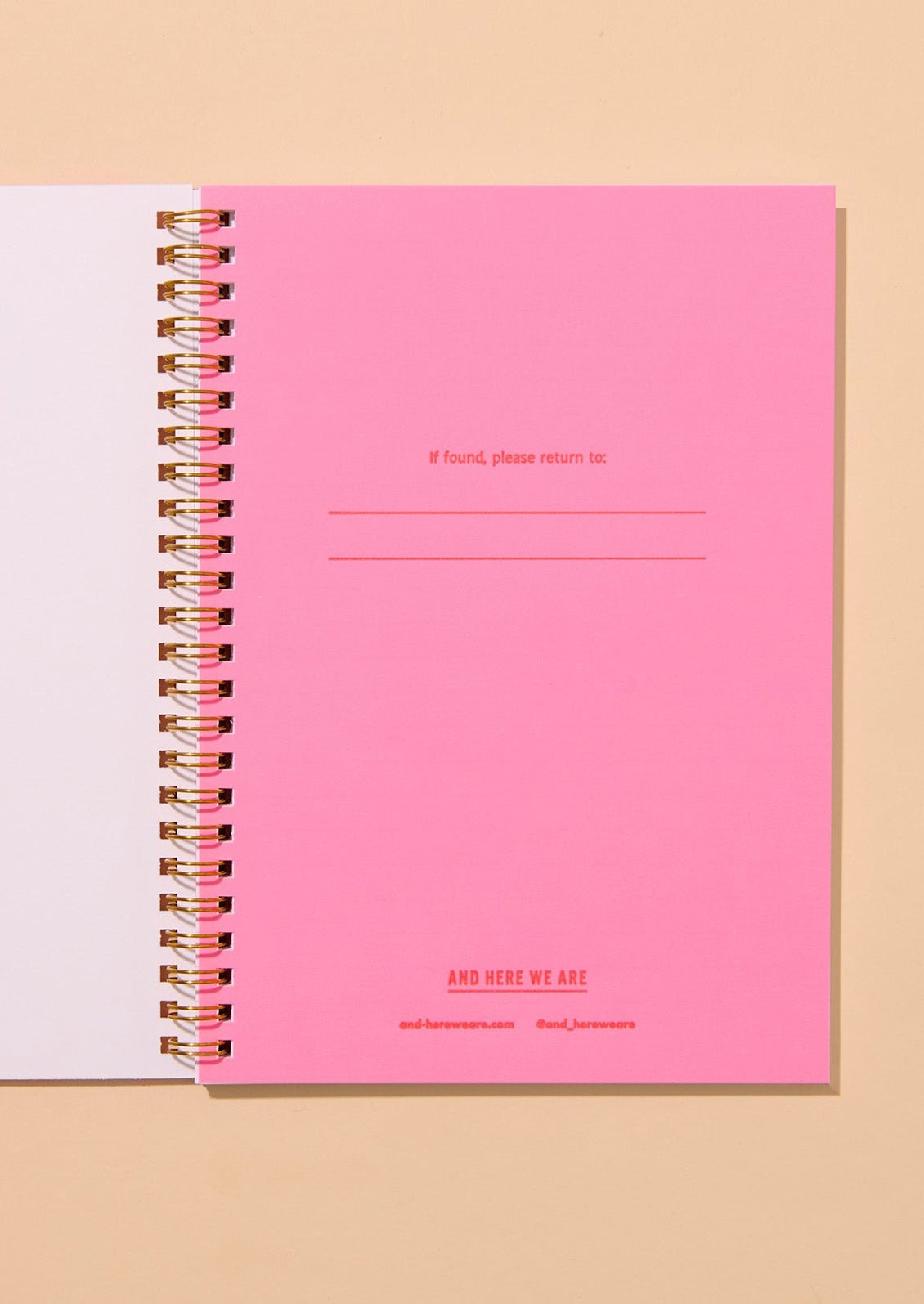 Pink notebook with text on a beige background