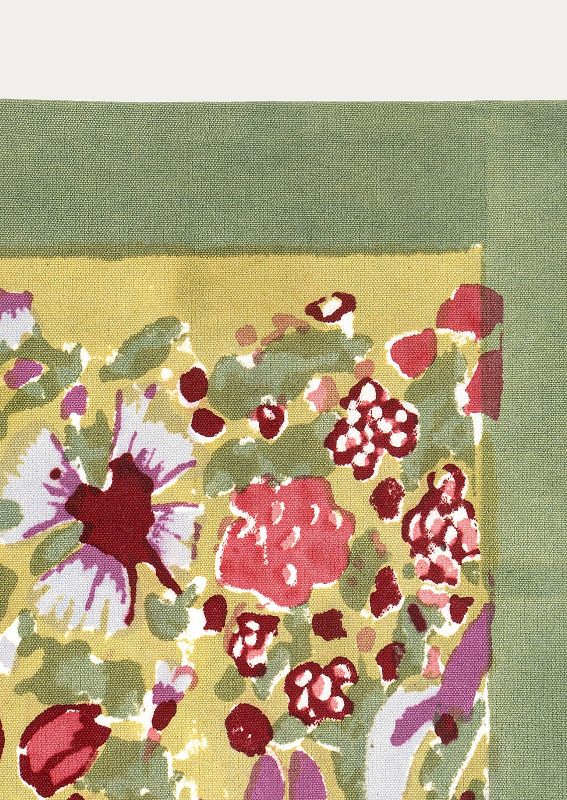 Floral patterned fabric with red, pink, and green colors on a green background