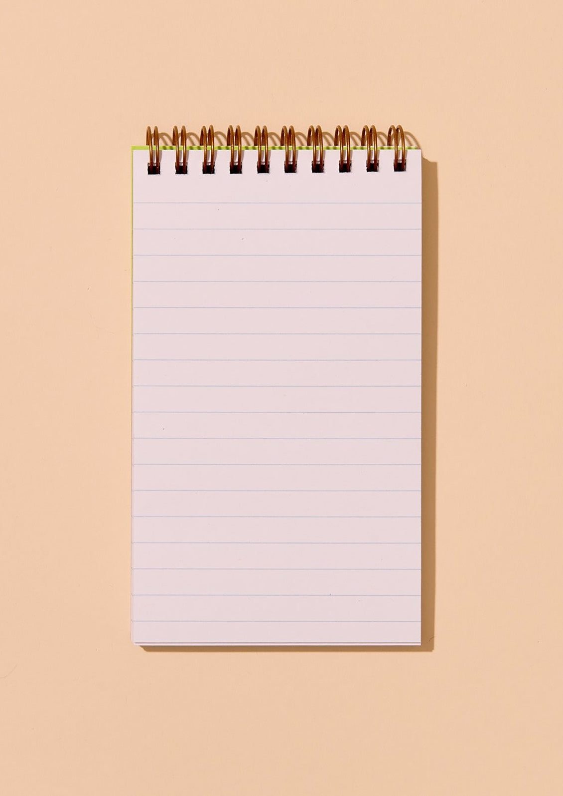 Ruled spiral-bound notebook on a beige background