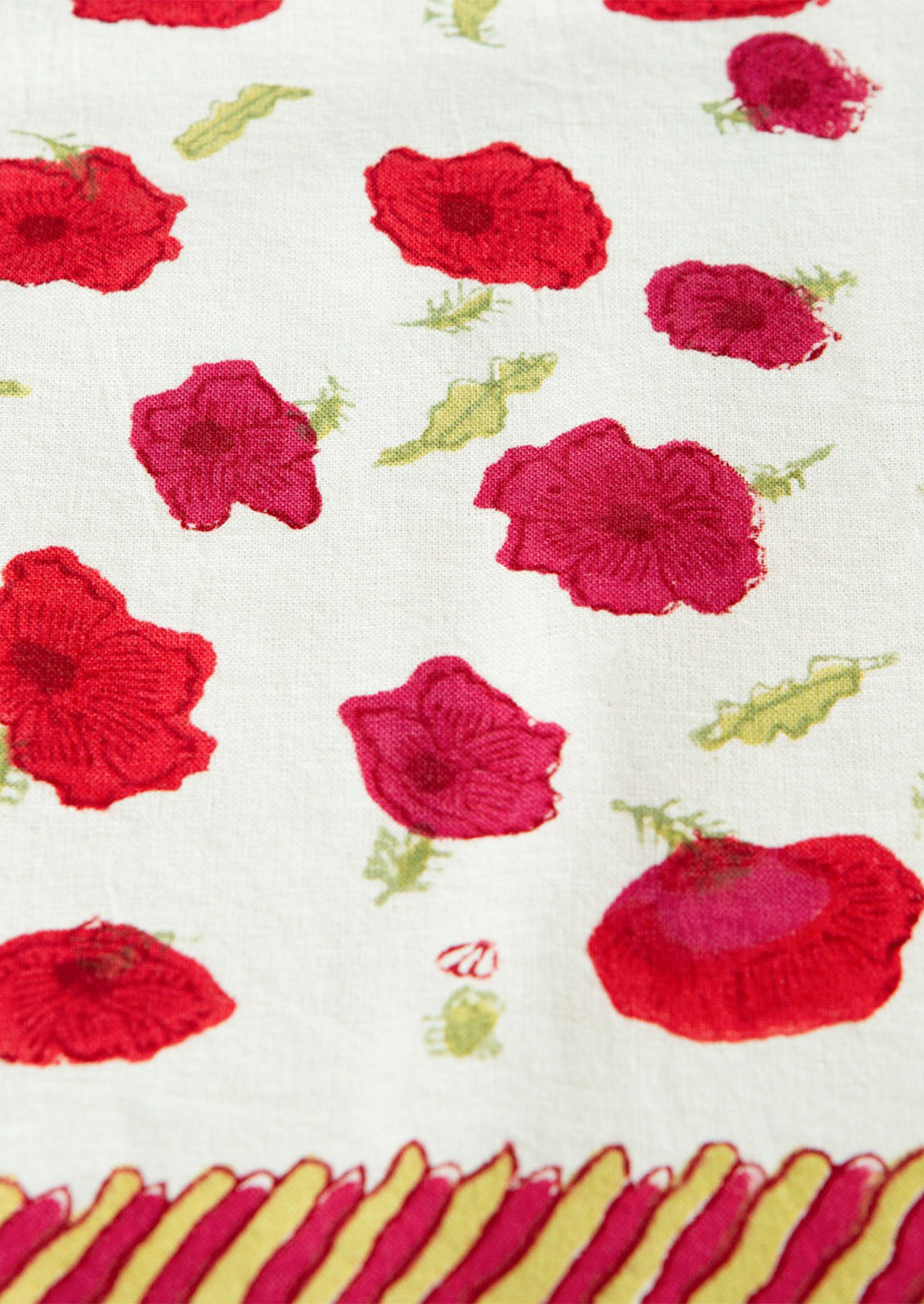 Fabric with red floral patterns on a white background