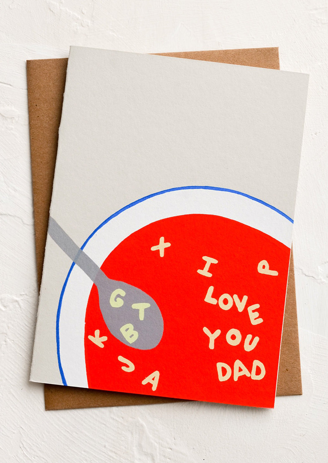 A greeting card with illustrated image of bowl of alphabet soup spelling "I love you dad".