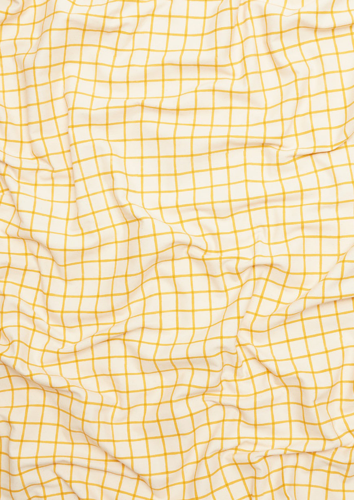 A tablecloth with white and yellow grid pattern.