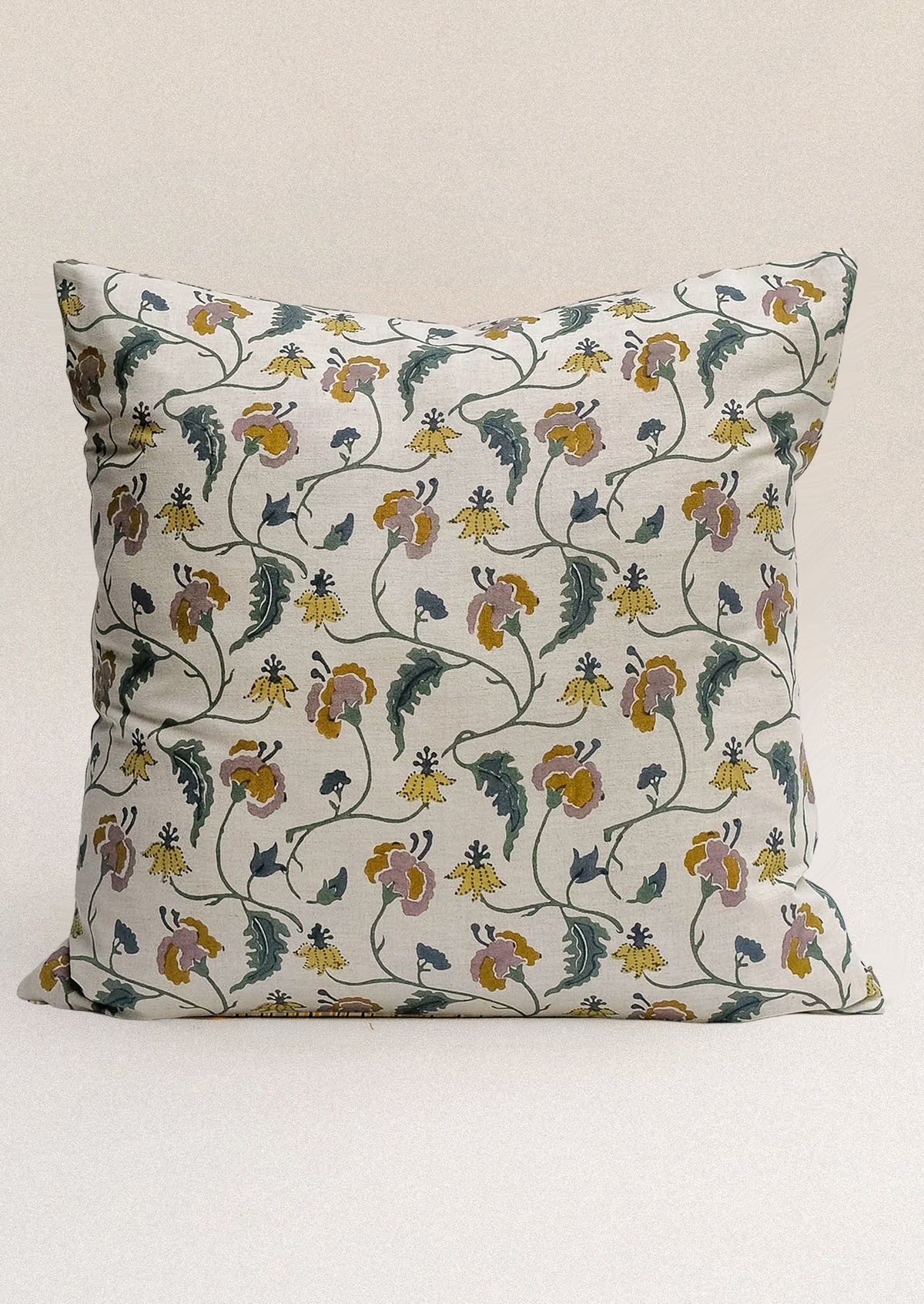 A block printed throw pillow with floral print on natural linen.