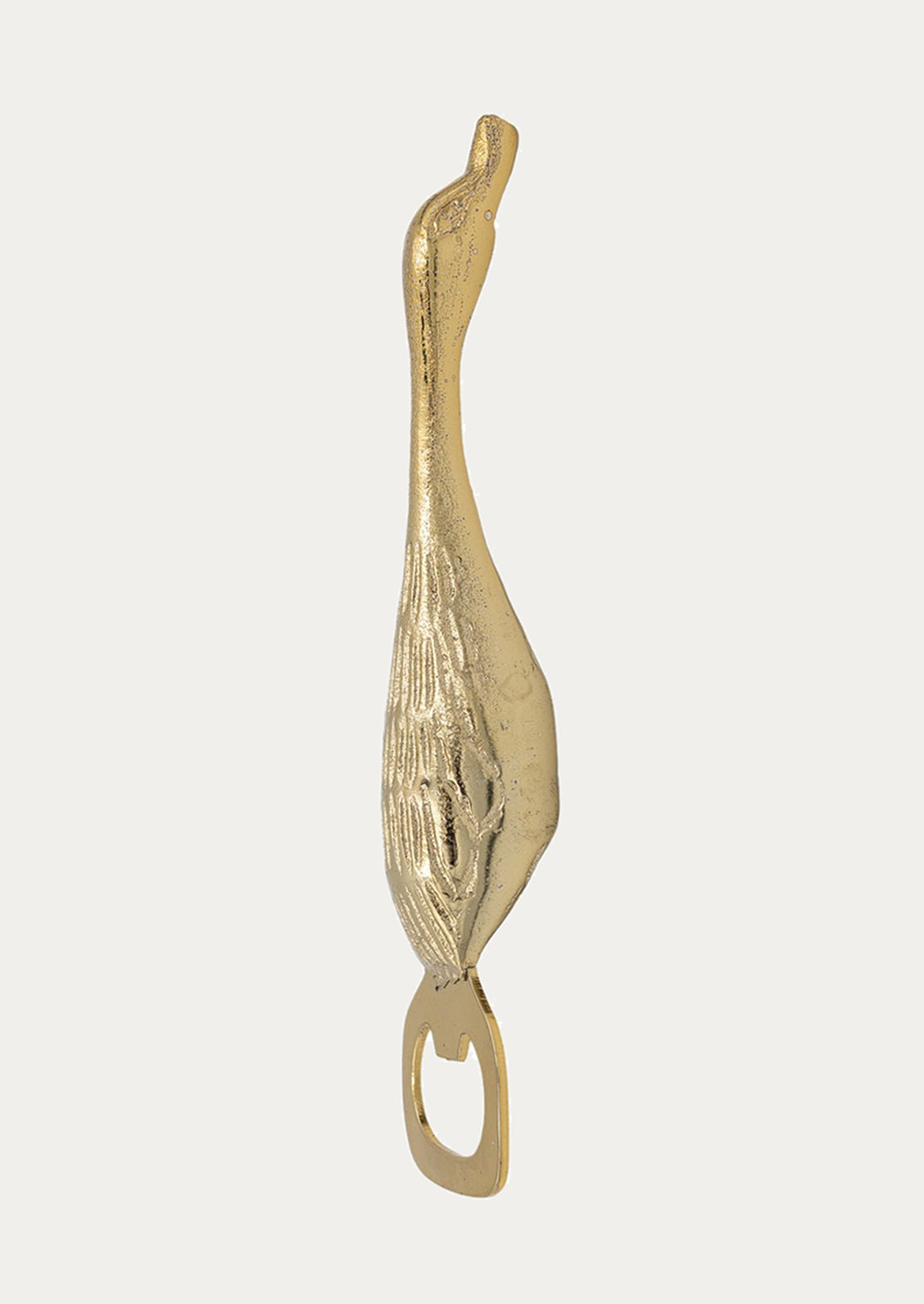 Gold bird-shaped bottle opener on a white background