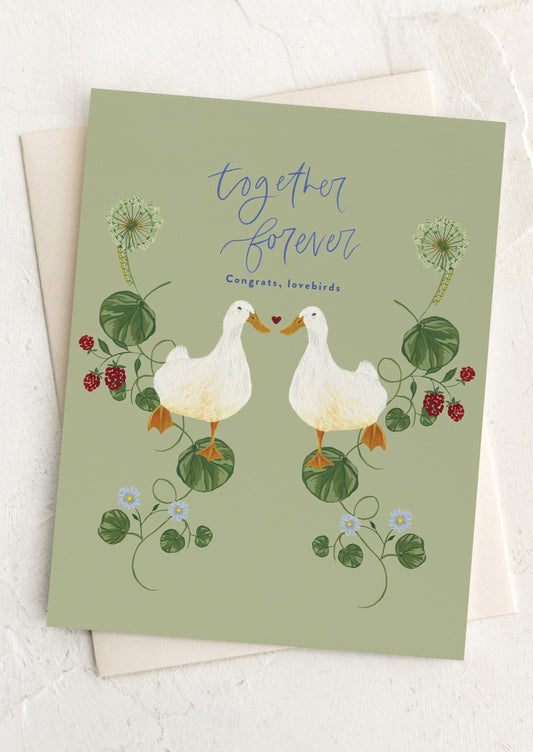 Greeting card with two ducks holding hands and the text 'Together Forever' on a light green background.