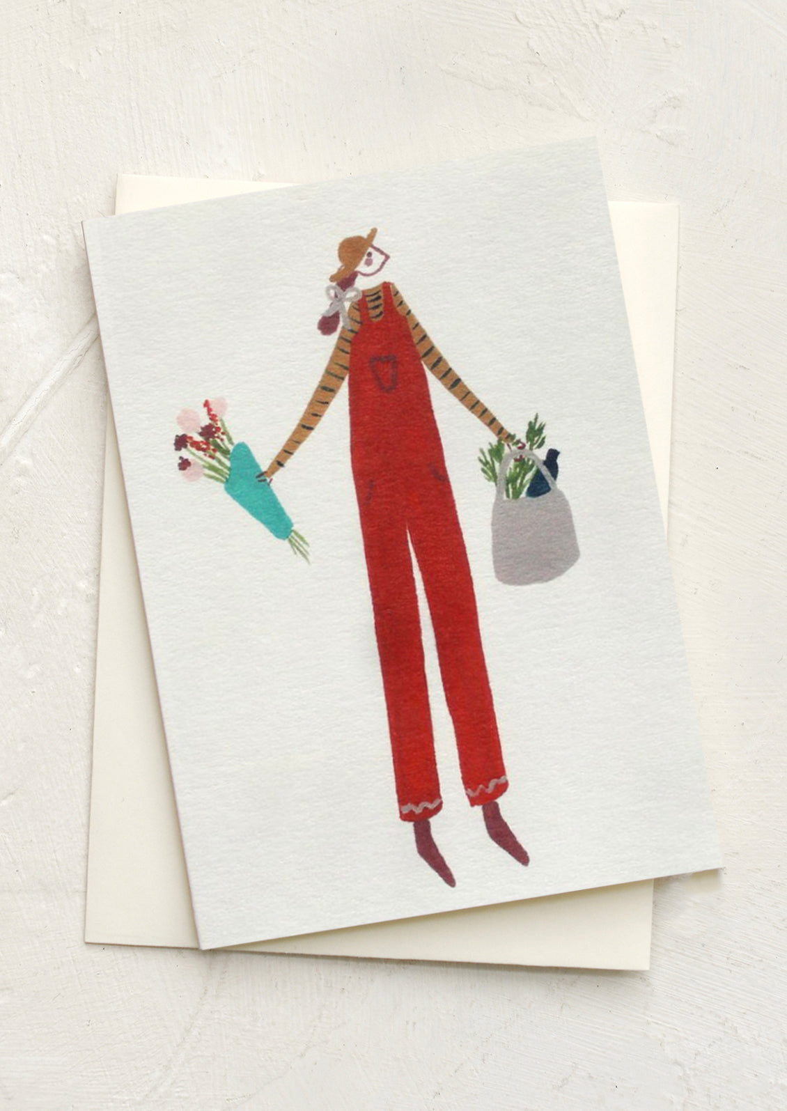 A mini card with illustration of woman wearing red dungarees.