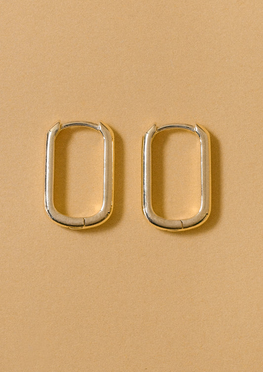 A pair of simple rectangular hoop earrings.