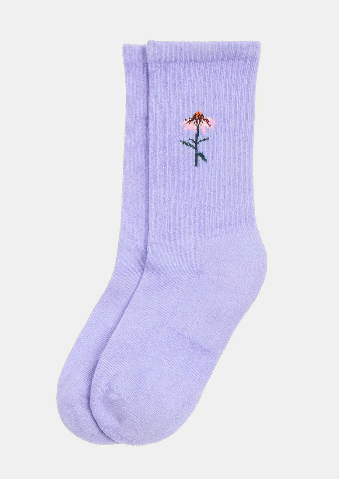 A pair of light purple crew socks with a small embroidered flower on the upper cuff, shown against a solid off-white background.