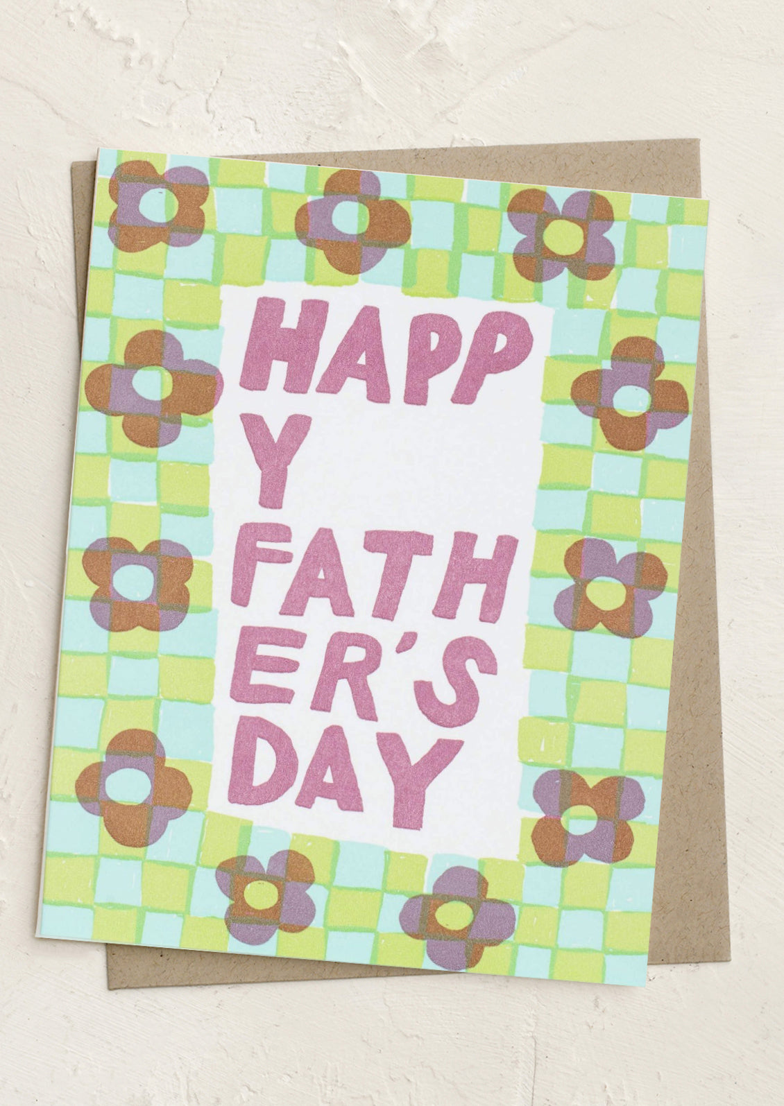 A greeting card with checkered border with flowers, text reads "Happy Father's Day".