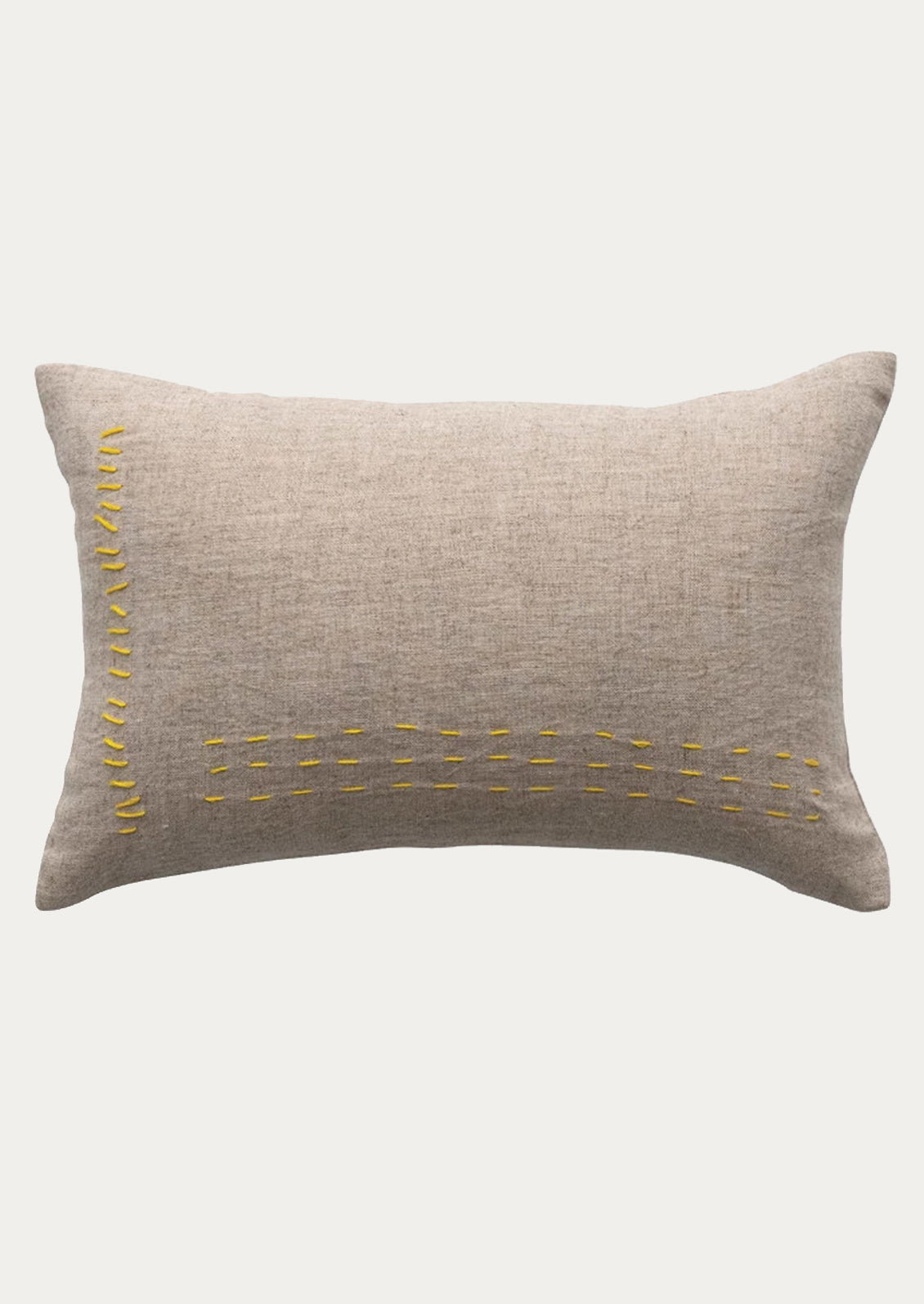 A linen lumbar pillow in natural linen with yellow stitching.