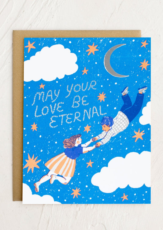A card reading "May your love be eternal" with moon and stars print.