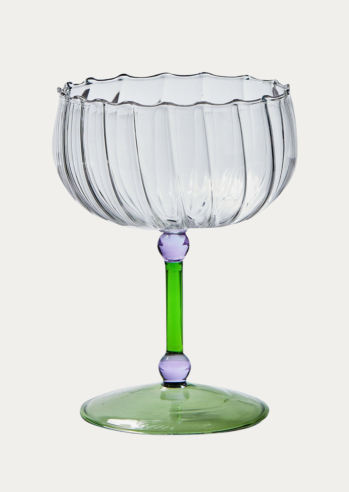 Clear glass coupe with small round purple details and a green stem and base.