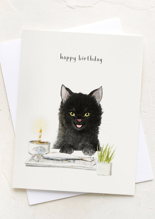 A card with illustration of cat eating a fish, text reads "happy birthday".