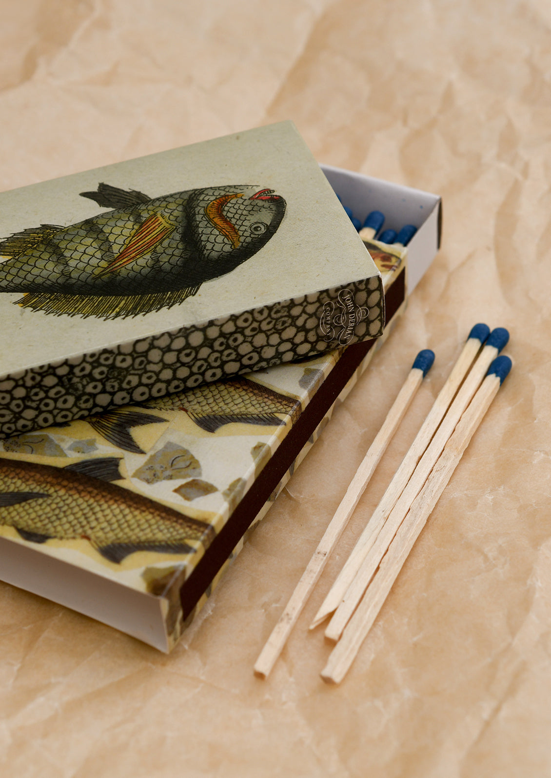 Printed matchboxes with fish patterns.
