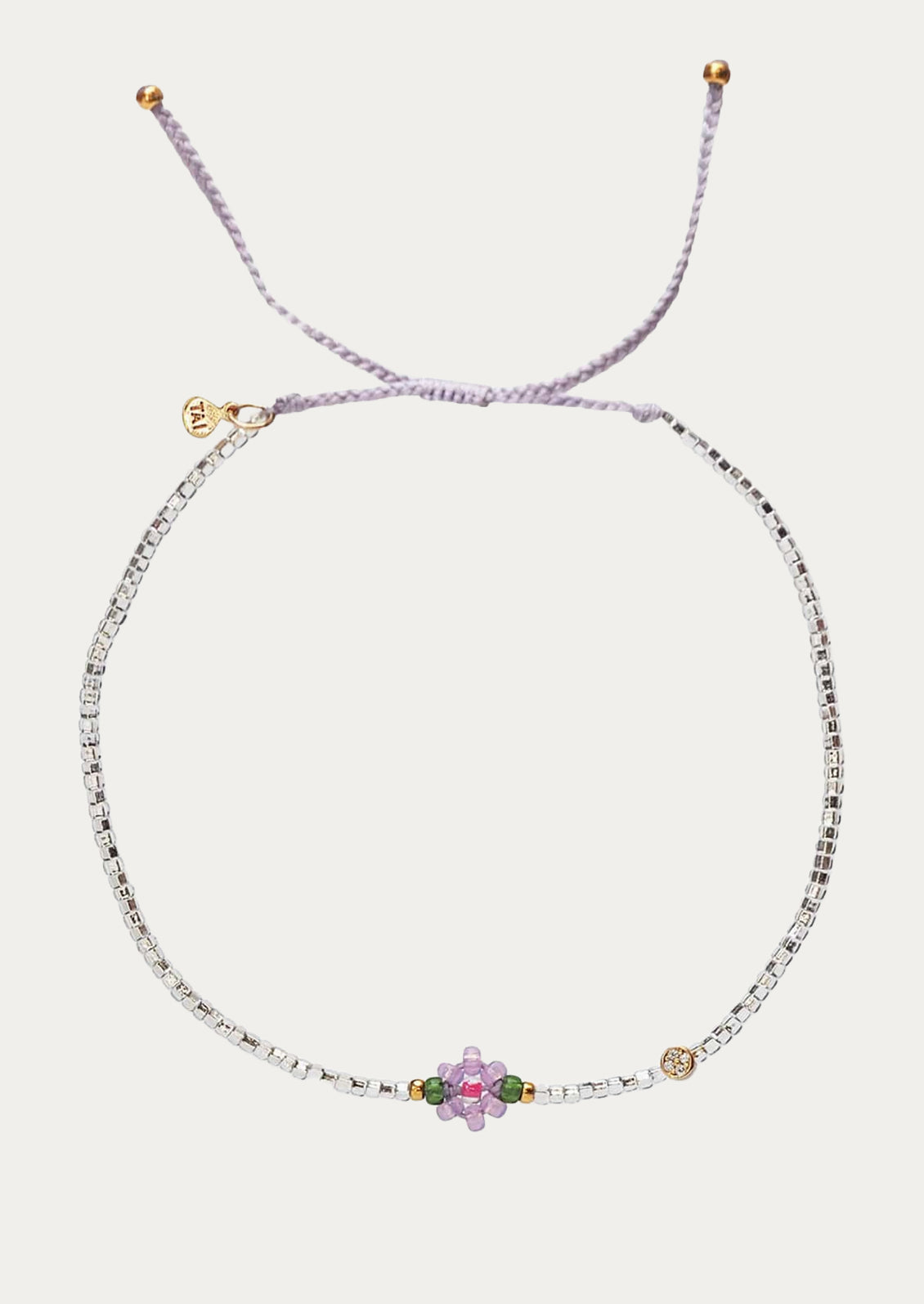 A beaded bracelet in silver and lavender with beaded flower charm.