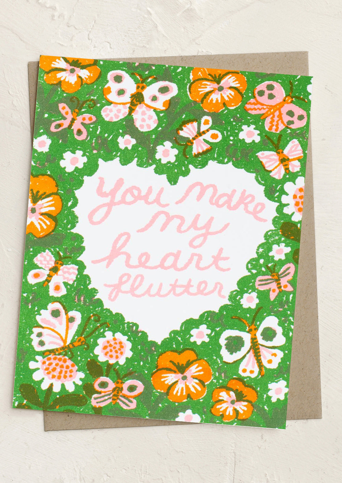 Greeting card with floral design and text 'You make my heart flutter' on a white background