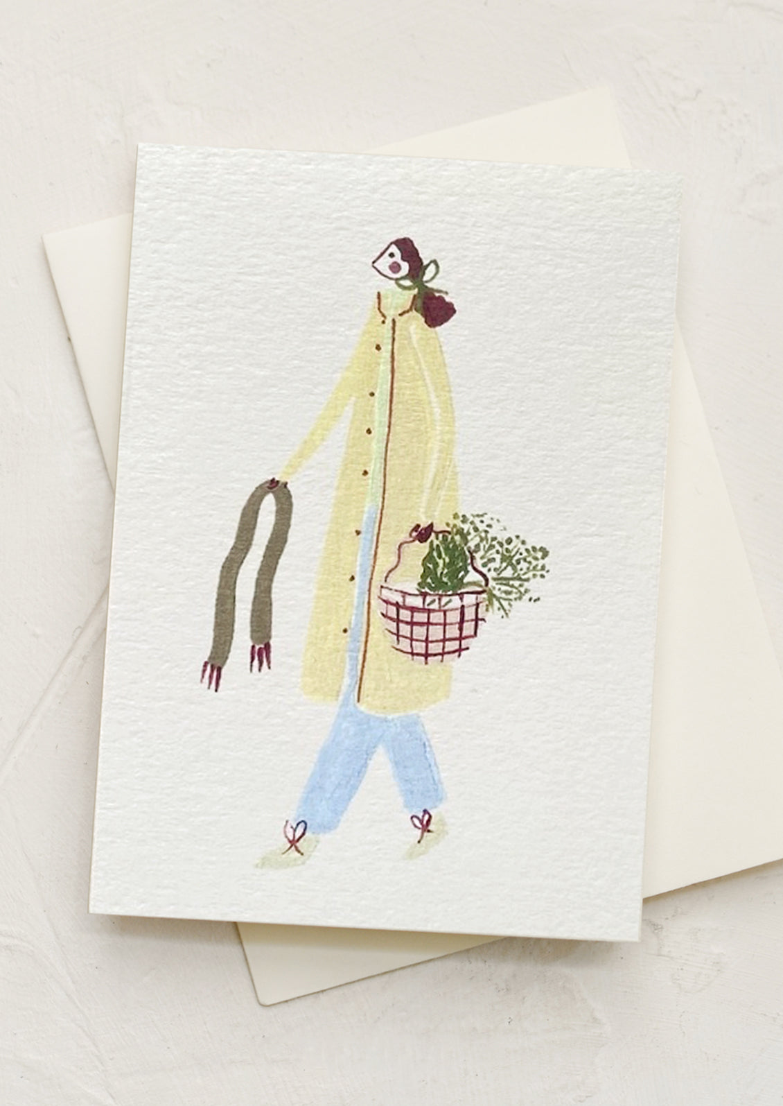 A mini card with illustration of woman carrying a basket.