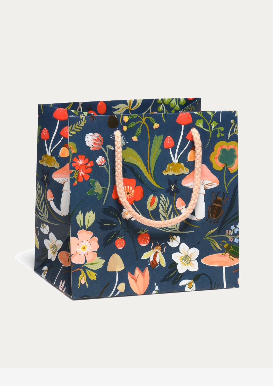 Floral-patterned gift bag with colorful flowers and mushrooms on a white background