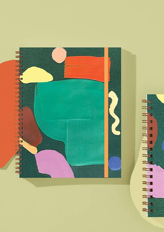 A multicolor painted notebook in green.