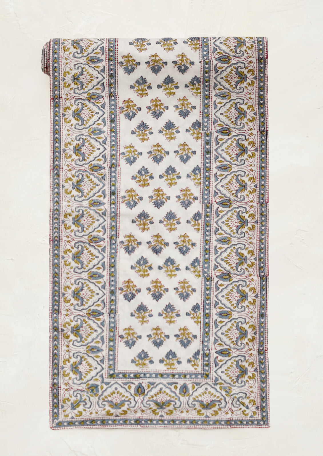 Cloth table runner with intricate pattern on a white background