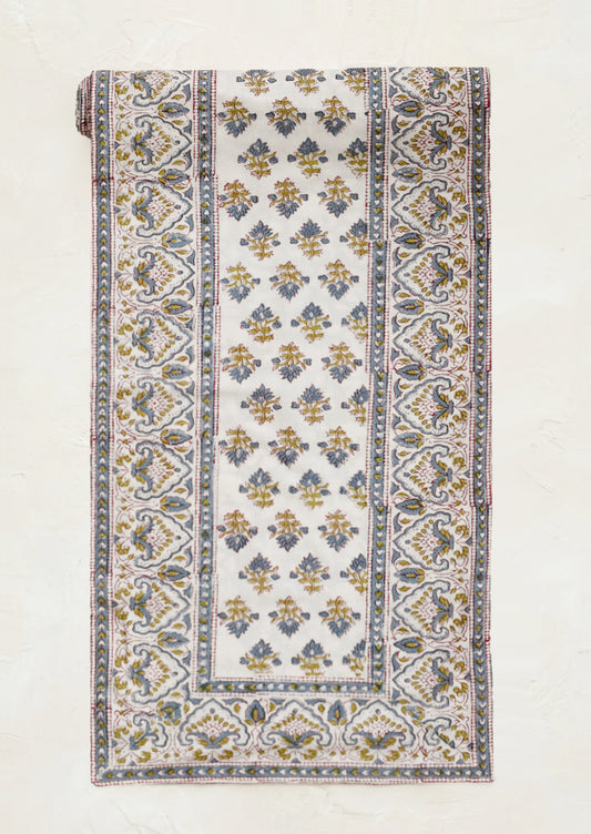 Cloth table runner with intricate pattern on a white background